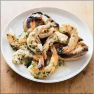  ?? DANIEL J. VAN ACKERE — AMERICA’S TEST KITCHEN VIA ASSOCIATED PRESS ?? This undated photo provided by America’s Test Kitchen in July 2018 shows grilled shrimp with spicy lemon-garlic sauce in Brookline, Mass. This recipe appears in the cookbook “Master Of The Grill.”