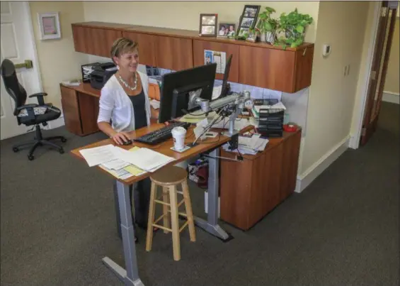  ?? DIGITAL FIRST MEDIA FILE PHOTO ?? Rose Walters makes use of her new standing desk in her office at the Pottstown Health Foundation. She is able to stand or sit which makes for a better working health benefit in the office environmen­t.