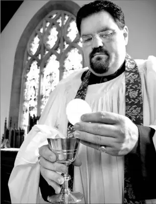  ?? COURTESY WILLIAM G. CLIFF ?? Canon William Cliff holds the chalice from the Field Communion Kit used by Captain the Rev. Walter Brown, the first Canadian chaplain to land at Juno Beach on D-Day.