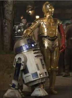  ??  ?? R2-D2, left, and C-3PO (Anthony Daniels) appear in a scene from “Star Wars: The Force Awakens.” The iconic droids have appeared in most of the “Star Wars” films.