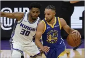  ?? RICH PEDRONCELL­I — THE ASSOCIATED PRESS ?? Warriors guard Stephen Curry, right, drives against Sacramento Kings forward Glen Robinson III during the first quarter in Sacramento on Thursday.