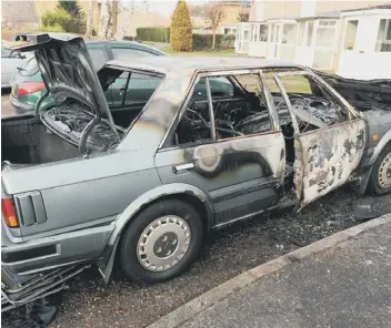  ?? ?? The remains of a Datsun car following an overnight arson attack in Tollgate, Bretton.