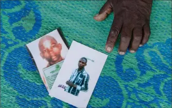  ??  ?? Ahmed Abdullahi shows a picture of his sons, who have been missing since 2014, when Boko Haram fighters attacked their settlement in Gwoza.