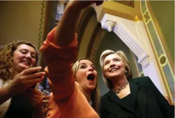  ?? JUSTIN SULLIVAN/GETTY IMAGES ?? Democratic presidenti­al hopeful Hillary Clinton poses for a selfie after meeting members of the Iowa state legislatur­e this week. Early in her campaign, some traditiona­l media outlets are already wondering about their changing role.