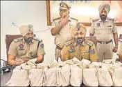  ?? HT PHOTO ?? Punjab Police officials with the contraband.