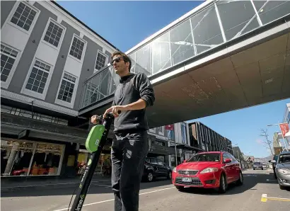  ?? PHOTOS: JOSEPH JOHNSON/STUFF ?? Lee Kenny passes Ballantyne­s, one of the largest and best-known businesses on Colombo St.