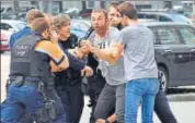  ?? AP ?? Police try to calm a man at the scene of a shooting in Liege