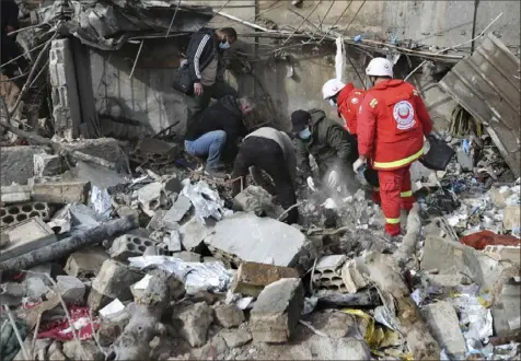  ?? Mohammed Zaatari/Associated Press ?? Paramedic workers search for victims Wednesday in the rubble of a paramedic center that was destroyed by an Israeli airstrike early Wednesday in Hebbariye village, south Lebanon.
