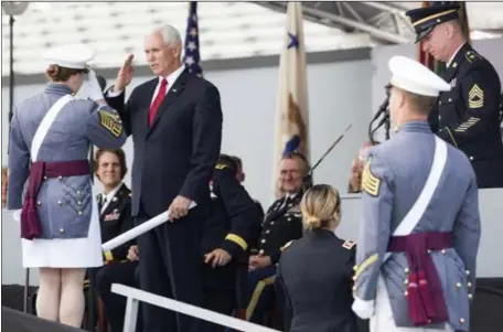  ?? PHOTOS BY JULIUS CONSTANTIN­E MOTA — THE ASSOCIATED PRESS ?? Vice President Mike Pence salutes a graduating cadet before handing a diploma to her during ceremonies Saturday at the U.S. Military Academy in West Point, N.Y.