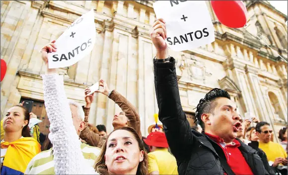  ?? (AP) ?? People gather in Bolivar Square to protest against President Juan Manuel Santos’ government and to denounce concession­s the government has made in peace talks with the Revolution­ary Armed
Forces of Colombia, or FARC, in Bogota, Colombia on April 2.