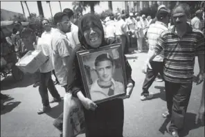  ??  ?? PICTURE: An Egyptian protester holds a picture of a relative killed in the 2011 Egyptian revolution during a demonstrat­ion against the Supreme Constituti­onal Court rulings on Friday in Alexandria, Egypt. Judges appointed by Hosni Mubarak dissolved the...