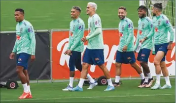  ?? (AFP) ?? (From L) Brazil’s defender Alex Sandro, Brazil’s forward Raphinha, Brazil’s forward Pedro, Brazil’s midfielder Everton Ribeiro, Brazil’s midfielder Fred and Brazil’s defender Alex Telles arrive for a training session on Monday at the Continassa training ground in Turin, northern Italy, as part of Brazil’s national football team preparatio­n ahead of the Qatar 2022 World Cup.