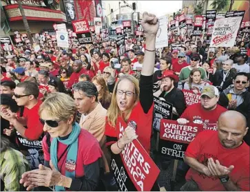 ?? Barbara Davidson Los Angeles Times ?? THOUSANDS march in support of the Writers Guild of America strike in Hollywood in November 2007. Writers lost more than $287 million in compensati­on during that 100-day strike, studios and networks say.