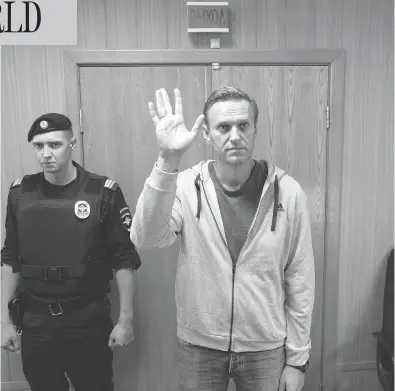  ?? PAVEL GOLOVKIN / THE ASSOCIATED PRESS ?? Russian opposition leader Alexei Navalny, shown here in a Moscow courtroom on Monday, has been sentenced to a month in jail for unsanction­ed protests held in January. This is the second 30-day jail term for Navalny this year.