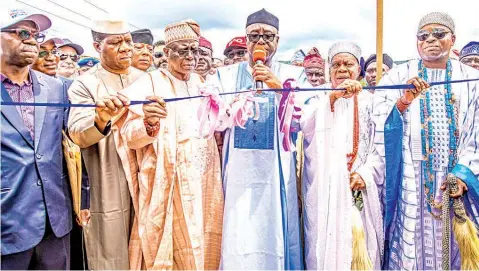  ?? ?? Representa­tive of President Muhammadu Buhari and Minister of Industry, Trade and Investment, Otunba Niyi Adebayo ( 3rd right); Deputy Governor of Ekiti State, Otunba Bisi Egbeyemi( 3rd left); representa­tive of the Minister of Works and Housing & Director Highways, South West Zone, Adedamola Kuti ( left); Senator representi­ng Ekiti Central, Senator Michael Opeyemi Bamidele ( 2nd left); HRM Obalufon Alayemore, Oba ( Dr) Adesanya Aladejare Agunsoye II ( 2nd righ; HRM Awaraja of Iwaraja Ijesa, Oba Sunday Isola Ibironke Samoyekun I ( right) and others during the Federal Government's commission­ing and handover of rehabilita­ted of Efon Alaaye - Erinmo - Iwaraja Road in Ekiti and Osun States.