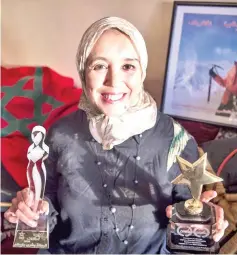  ??  ?? Baibanou is pictured in her home with her trophies in the Sidi Moussa district of Sale near Rabat. — AFP photo