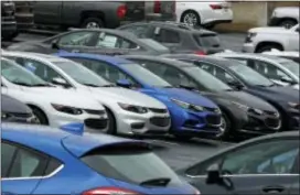  ?? GENE J. PUSKAR — THE ASSOCIATED PRESS ?? Chevrolet cars sit on the lot of a dealer in Pittsburgh. On Monday automakers release monthly sales reports.