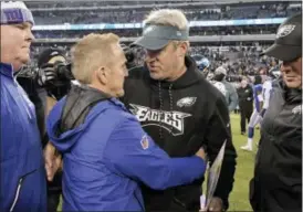  ?? BILL KOSTROUN — THE ASSOCIATED PRESS ?? New York Giants interim head coach Steve Spagnuolo, left, and Philadelph­ia Eagles head coach Doug Pederson talk after an NFL football game Sunday in East Rutherford, N.J.