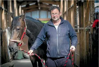  ?? KAVINDA HERATH/STUFF ?? Ryal Bush trainer Brett Gray holds You’re So Fine, a possible starter in the $30,000 New Zealand Kindergart­en Stakes at Wyndham on March 31.