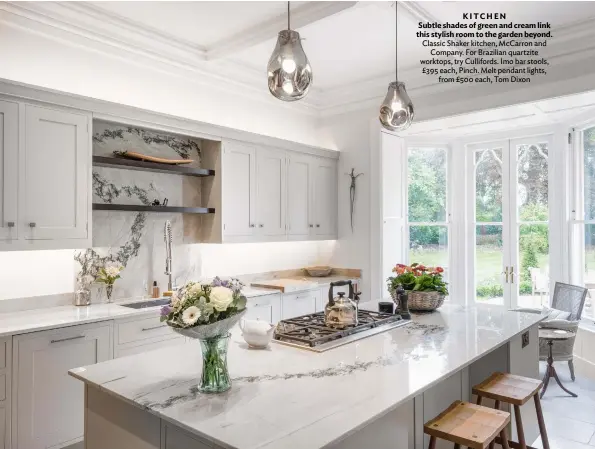  ?? ?? KITCHEN
Subtle shades of green and cream link this stylish room to the garden beyond. Classic Shaker kitchen, Mccarron and Company. For Brazilian quartzite worktops, try Cullifords. Imo bar stools, £395 each, Pinch. Melt pendant lights, from £500 each, Tom Dixon