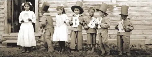  ??  ?? Children at Fort Simpson Indian Residentia­l School in the Northwest Territorie­s hold letters that spell the word “Goodbye,” circa 1922. The trauma of the residentia­l school system created by John A. Macdonald’s government continues to affect Indigenous peoples today.