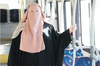  ??  ?? Warda Naili wears a niqab on a city bus in Montreal during the weekend.