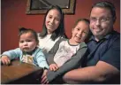  ?? WM. GLASHEEN/USA TODAY NETWORK-WISCONSIN ?? Daisy and Sam Roth with their daughters, Abigail and Adalynn, at their home in Neenah. The family has been reunited after, while visiting family, the girls and their mother were stuck in Wuhan, China, during the coronaviru­s outbreak.