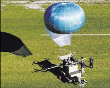  ?? The Associated Press ?? This tethered balloon is called a Winch Aerostat Small Platform, or WASP. The U.S. Border Patrol is considerin­g another type of surveillan­ce balloon to spot illegal activity. It’s part of an effort to see if more eyes in the sky translate to fewer...