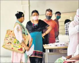  ??  ?? A health worker collects swab sample of a resident at Goregaon (West) on Monday.