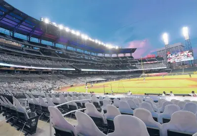  ?? JOHN AMIS/AP ?? During the shortened 2020 season, cardboard cutouts of fans occupied seats at a baseball game in Atlanta.