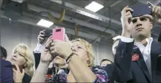  ??  ?? Supporters use their mobile devices to record President Donald Trump.