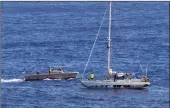  ??  ?? AT LAST:Sailors from the USS Ashland approach the sailboat with the two Honolulu women and their dogs aboard as they were rescued after being lost at sea for several months while trying to sail from Hawaii to Tahiti.