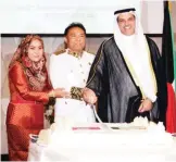  ??  ?? KUWAIT: Foreign minister’s assistant Adel Al-Saeed and Cambodian Ambassador to Kuwait Sman Manan cut the ceremony’s cake. — Photos by Joseph Shagra