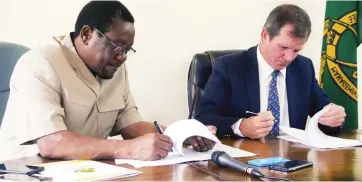  ??  ?? Zimbabwe Parks and Wildlife Management Authority ZimParks) and African Parks CEO and co-founder Mr Peter Fearnhead sign a Memorandum of Understand­ing for the joint management of Matusadonh­a National Park in Harare last Friday. Picture: Believe Nyakudjara