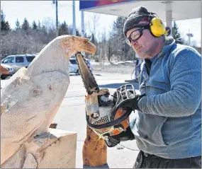  ?? PHOTO BY SAM MACDONALD ?? Rob Milner prepares to carve an eagle out of a block of wood on East River Road in New Glasgow on March 19. He donated the eagle to Special Olympics.