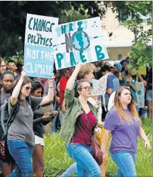  ??  ?? People begin to march from City Hall during the Oklahoma City Climate Strike event Friday. [NATE BILLINGS/ THE OKLAHOMAN]