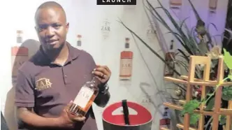  ??  ?? LAUNCH PULE Malahlela with a bottle of recently launched ZAR Whiskey.