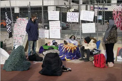  ?? JIM MONE — THE ASSOCIATED PRESS ?? Protesters at the Hennepin County Government Center on Tuesday in Minneapoli­s, as the trial for former Minneapoli­s police officer Derek Chauvin continues. Chauvin is charged with murder in the death of George Floyd during an arrest last May.