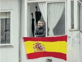  ??  ?? Imagen
Un vecino de la calle despliega una bandera de España.