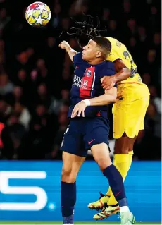  ?? — AFP file photo ?? Paris Saint-Germain’s forward Mbappe (LEFT) and Barcelona’s defender Jules Kounde fight for the ball during the UEFA Champions League quarter final first leg match at the Parc des Princes stadium in Paris.