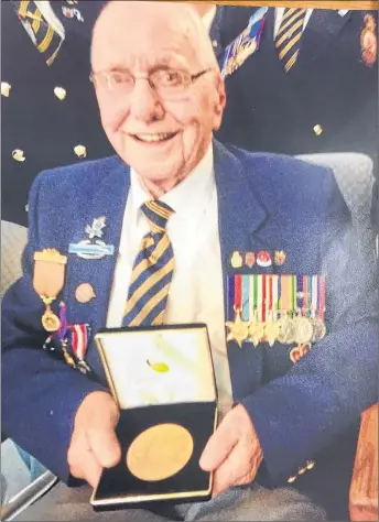  ?? SUBMITTED ?? A photo of Gordon MacDougall of Thorburn holding the Bronze Medallion he received from the United States government. MacDougall recently passed away and his children decided to donate his medals to the Pictou County Military Museum.