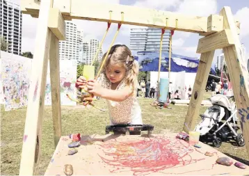  ?? ?? A child creates art at the festival.
