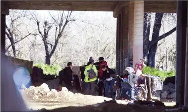  ?? NEWS-SENTINEL FILE PHOTOGRAPH­S ?? People gather at a homeless camp under Highway 99 at Turner Road in 2019. On Wednesday the Lodi City Council approved a plan to begin engaging the community in developing a homeless center.