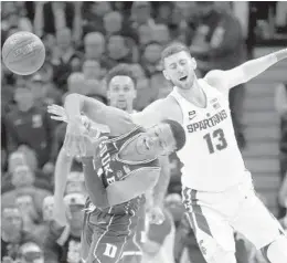  ?? CHARLES REX ARBOGAST/AP ?? Michigan State forward Ben Carter (13) and Duke guard Trevon Duval collide while scrambling for the ball on Tuesday in Chicago. Duke won 88-81.