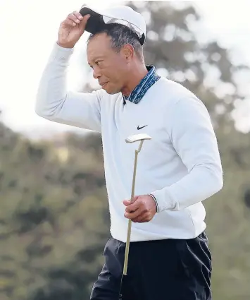  ?? GREGORY SHAMUS/GETTY ?? Tiger Woods tips his hat to the crowd after finishing his round at the Masters on Saturday.