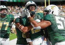  ?? Cooper Neill / Getty Images ?? Baylor’s Denzel Mims (15) celebrates with his teammates after scoring the game-winning touchdown with 7 seconds to play.