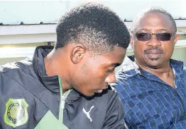  ?? FILE ?? Calabar High’s coach Michael Clarke (right) and his star athlete, Christophe­r Taylor.