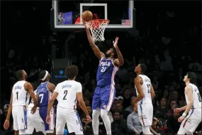  ?? JASON DECROW - THE ASSOCIATED PRESS ?? Joel Embiid goes to the basket against the Brooklyn Nets during the third quarter Saturday.