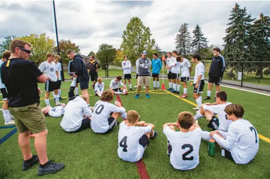  ?? APRIL GAMIZ/MORNING CALL PHOTOS ?? Northweste­rn Lehigh’s soccer team receives halftime instructio­ns from head coach Nate Hunsicker during a 2021 game.