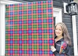  ?? ELIZABETH PATTERSON/CAPE BRETON POST ?? Shannon Forrester opens the tartan door to her new business endeavour, the Forrester Centre on Coxheath Road.